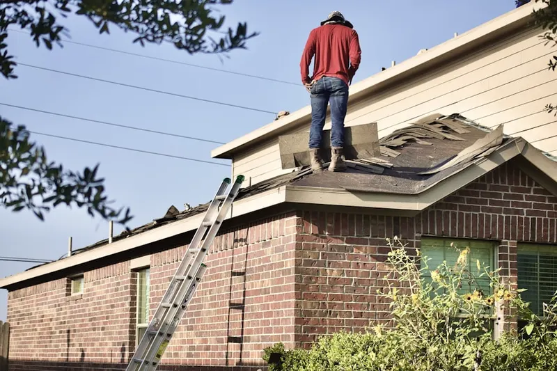 Professional roofer working on a residential roof in Central Islip